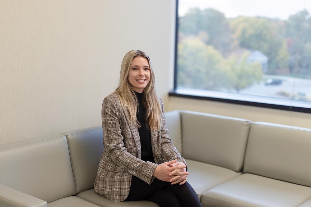 Photo of Frontiers intern Sidney Johnson sitting on couch in Frontiers office