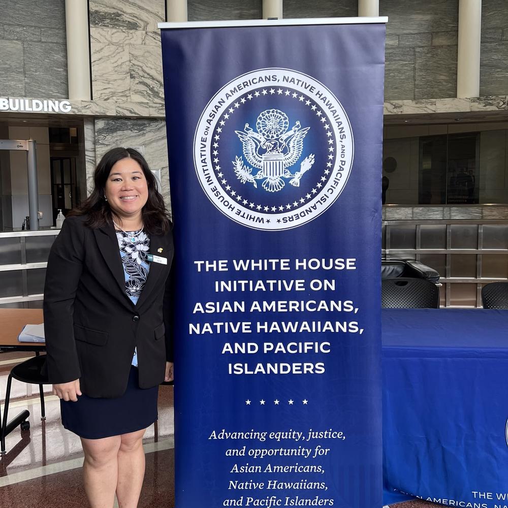 Frances Yang with sign at White House event