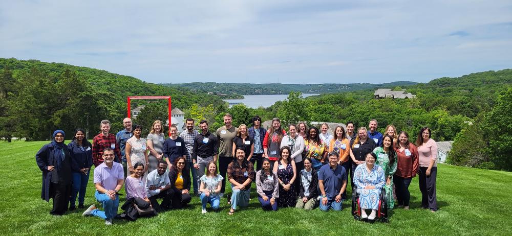 group photo of attendees at workshop with lake in background