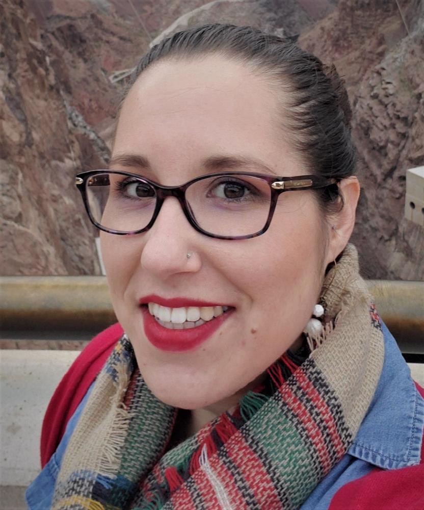 smiling woman with glasses and scarf