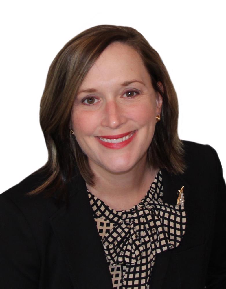Smiling woman in black jacket and gold and black checked top with a bow