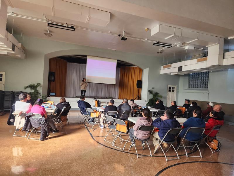 Photo of group listening to speaker