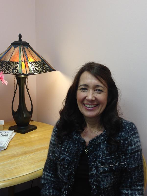 Photo of Lisette Jacobson at her desk at KU Medical Center Wichita