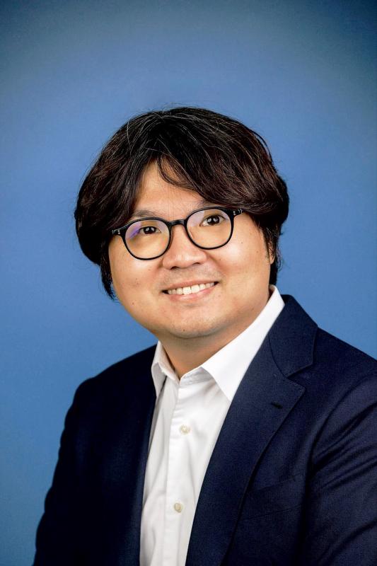 photo of Hyunjoon Kim in navy blazer, white button up shirt and glasses