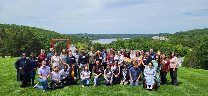 group photo of attendees at workshop with lake in background