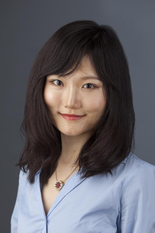 Photo of smiling Panying rong in blue shirt with gold necklace with red middle