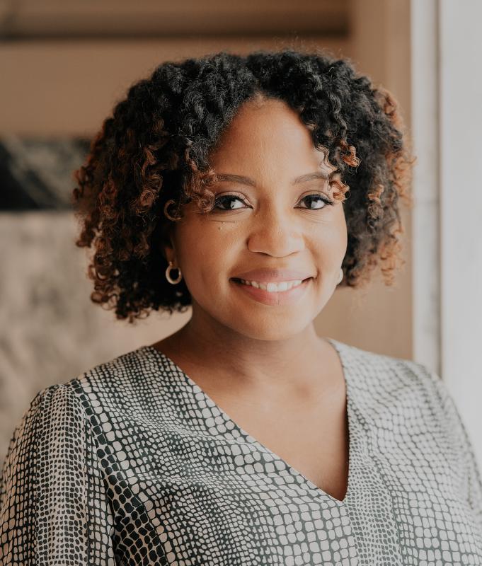 April McNeil-Johnson wearing gray and black dress