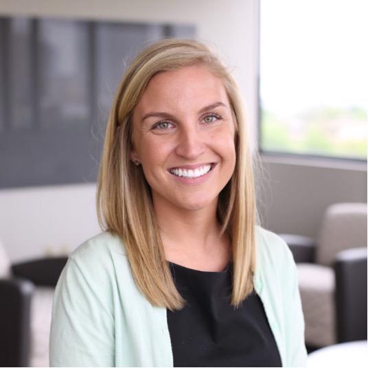 Image of Elly Leavens wearing a black shirt and light green sweater