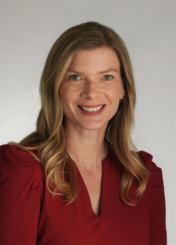 Woman smiling at camera wearing a red shirt
