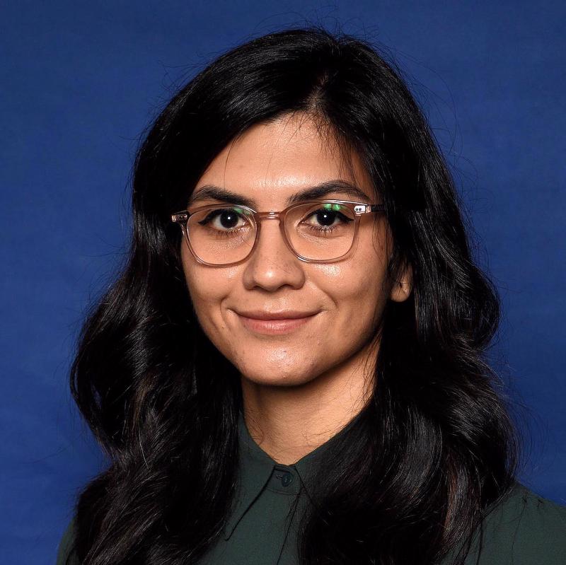 Smiling woman wearing glasses and green shirt