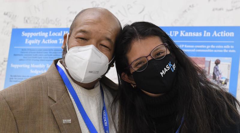 man and woman wearing masks