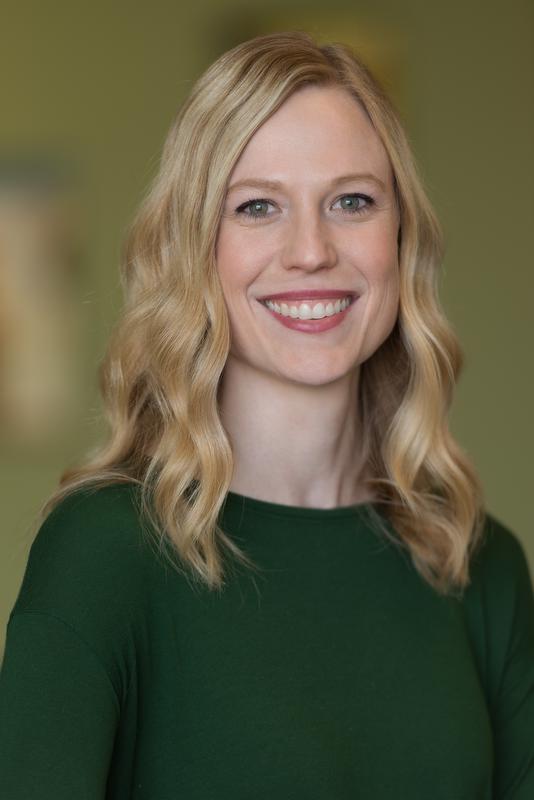 smiling woman in green shirt