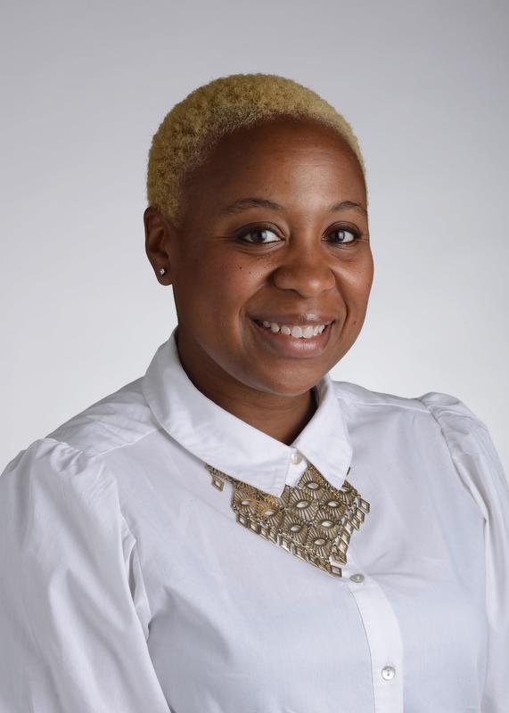 photo of woman wearing white shirt with a gold necklace