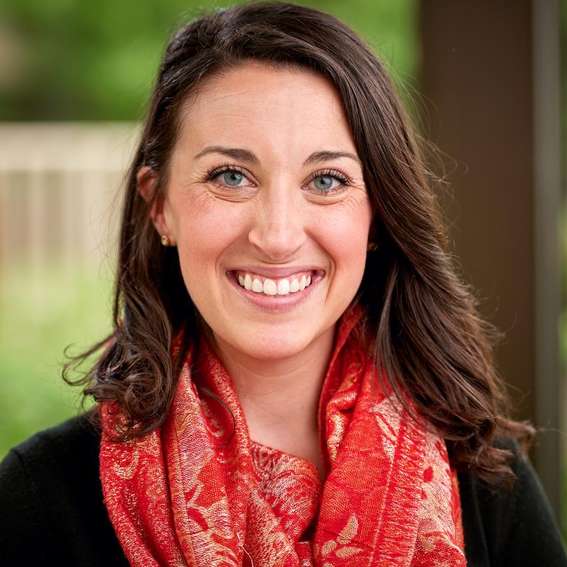 smiling woman with black shirt and red scarf
