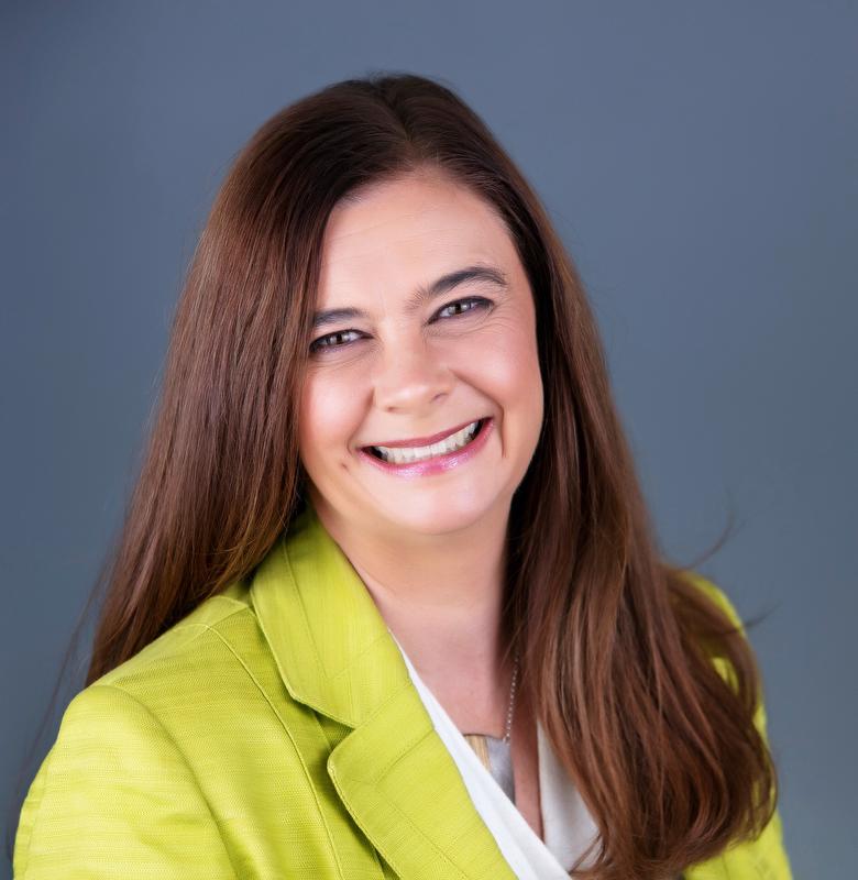 smiling woman wearing white shirt and lime green jacket