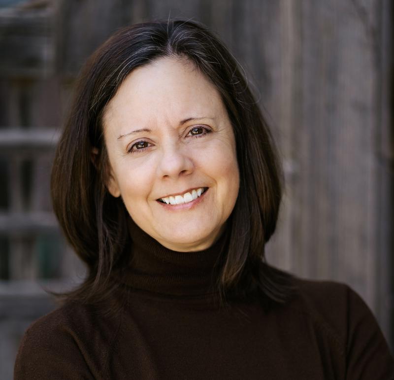 smiling woman in dark color shirt