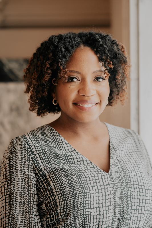 smiling woman in black and white shirt