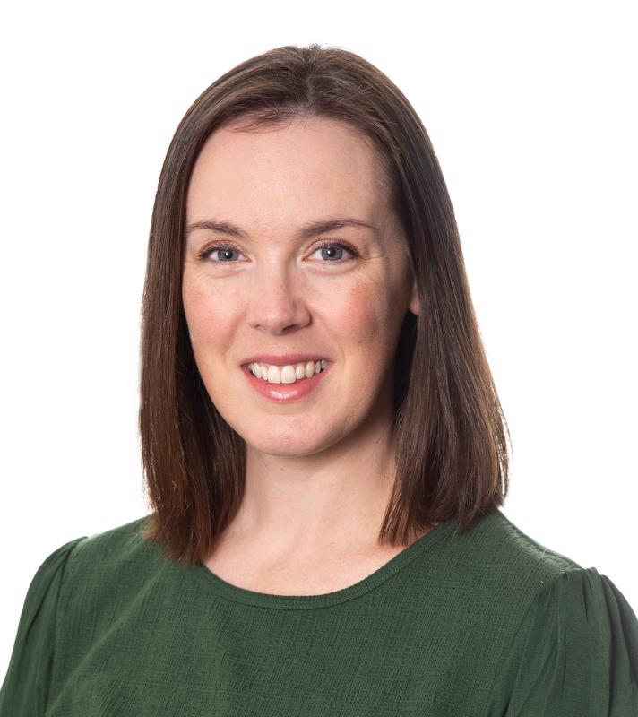 smiling woman in green shirt