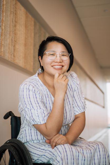 woman in white and blue stiped dress sitting in wheelchair