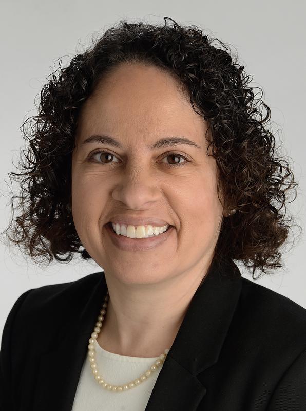 smiling woman  wearing black jacket, white shirt and necklace