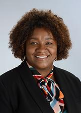 smiling woman wearing black jacket and multicolored scarf