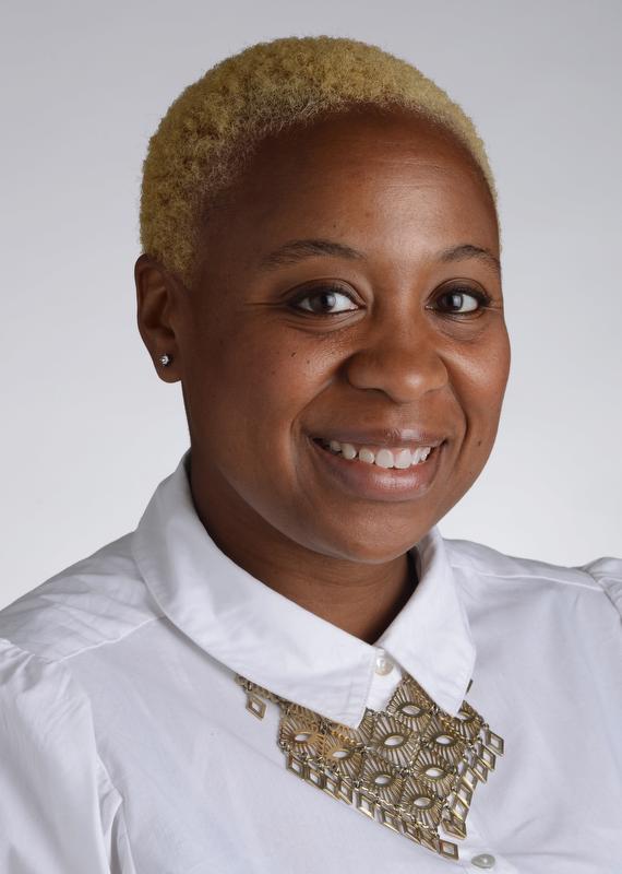 smiling woman wearing white shirt with gold necklace