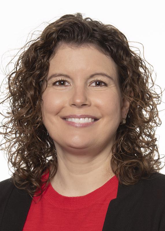 smiling woman wearing black jacket with red shirt