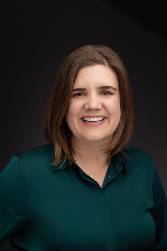 smiling woman in green button up shirt